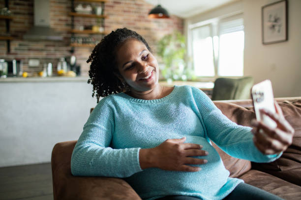istock Young pregnant woman using a smart phone at home 1488604138