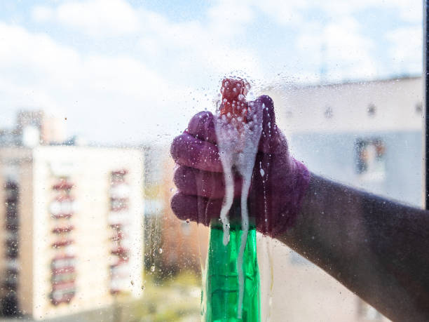 istock spraying of washing liquid on surface of window 1488604605