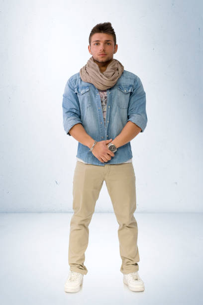 istock Handsome young man standing with denim shirt and scarf 1488605638