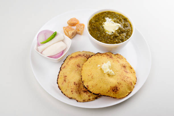 istock Sarson saag with corn chapati served with white makhan and jaggery in plate isolated on white background 1488607246