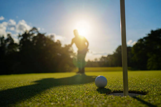 istock Blurred golfer playing golf in the evening golf course, on sun set evening time. 1488609058