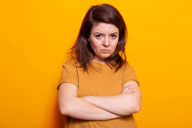 istock Upset woman standing with crossed arms in studio 1488609711