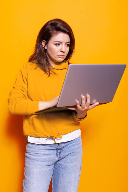 istock Modern person holding laptop to use technology on camera 1488611133