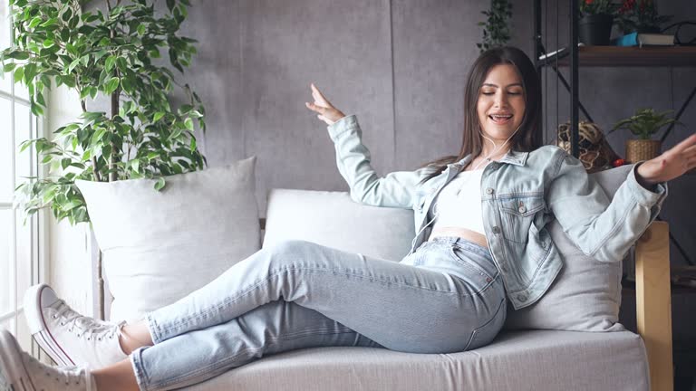 Female Enjoying Free Day With Music And Dance At Home