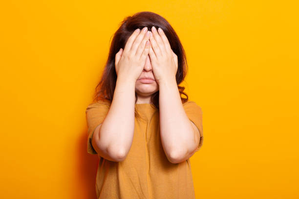 istock Stressed person covering face and eyes with hands 1488611829