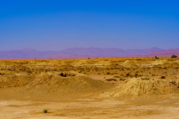 View of Sahara Desert landscape with remains of an ancient underground irrigation system. Morocco