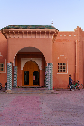 Ouarzazate, Morocco - April 03, 2023: Sunset view of the local mosque entrance, in Ouarzazate, Morocco