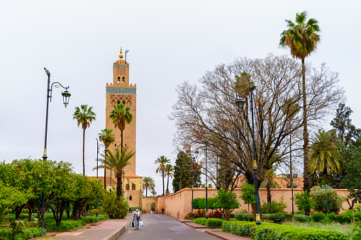 Marrakesh, Morocco - April 05, 2023: View of the historic Kutubiyya Mosque, with locals, in Marrakesh, Morocco