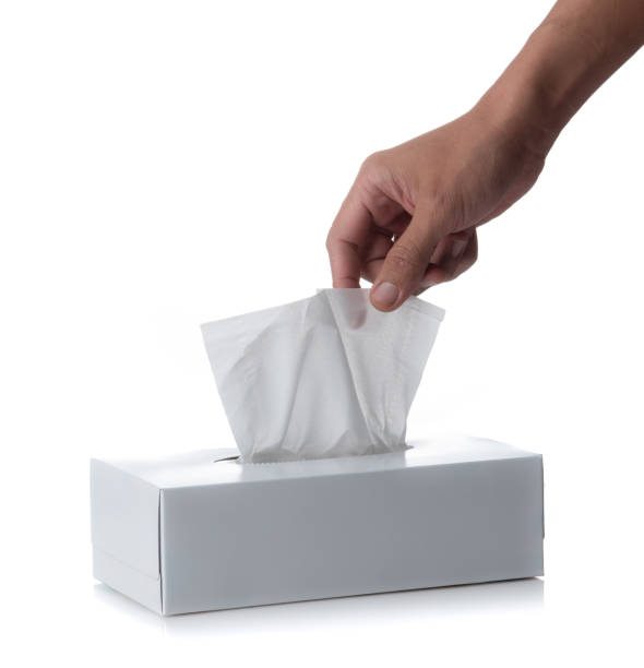 istock Male hand pulling white facial tissue from a box isolated on a white background 1488613620