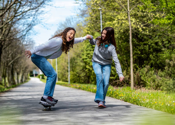 istock a girl skates and another follows her 1488613643
