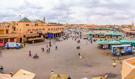Marrakesh, Morocco - April 05, 2023: Scene of the Jemaa el-Fnaa square, with various stalls, locals, and visitors, in Marrakesh, Morocco