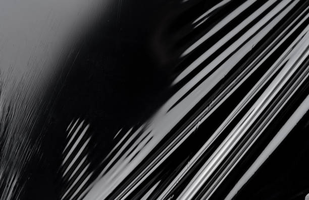 istock Transparent plastic wrap texture on the black background. Plastic bag texture. Reusable trash and waste. 1488615403