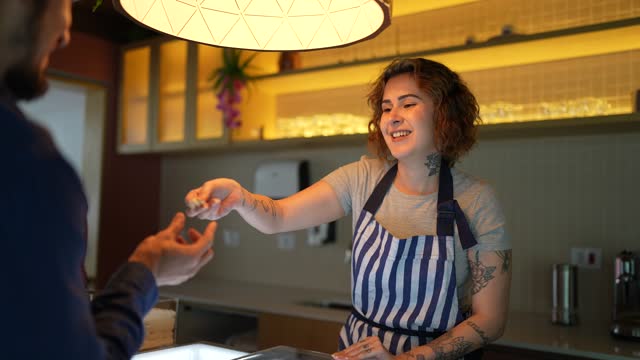 Saleswoman serving ice cream to a customer in an ice cream shop