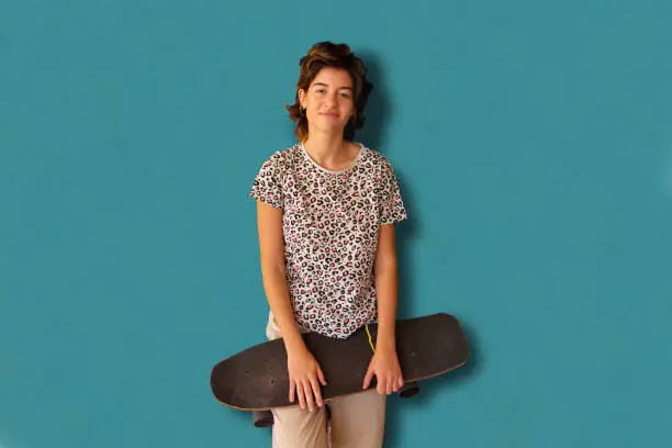 Generation Z skater girl portrait. Very happy. Outdoors. Looking at the camera