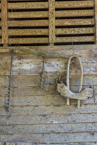 An antique wooden yoke used on a wagon for cattle to pull.