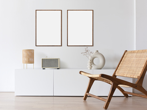 View of modern interior design. Minimalism boho style. Blank white empty frame mock up for painting or poster.