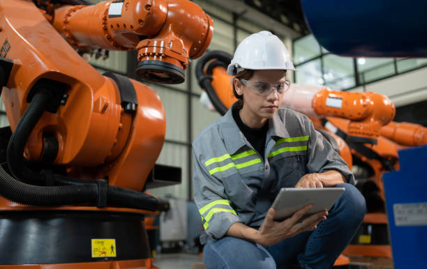 istock A female engineer installs a program on a robotics arm in a robot warehouse. And test the operation before sending the machine to the customer. 1488620425