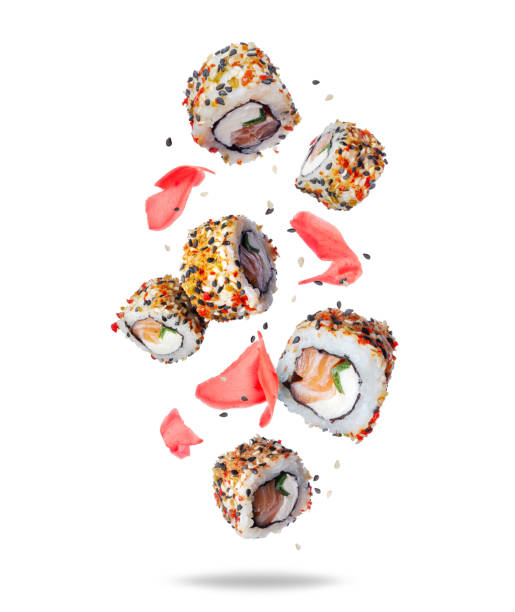 istock Fresh sushi rolls with ginger in the air isolated on white background 1488620595