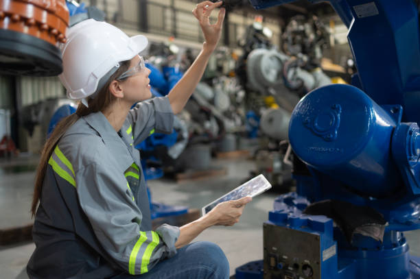 istock A female engineer installs a program on a robotics arm in a robot warehouse. And test the operation before sending the machine to the customer. 1488620617