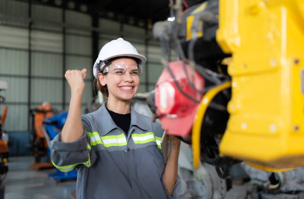 istock In the robots warehouse, Female engineer happily with updating software and calibrating a robotics arm. 1488620831