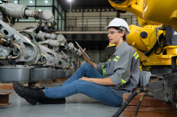 istock A female engineer installs a program on a robotics arm in a robot warehouse. And test the operation before sending the machine to the customer. 1488620906