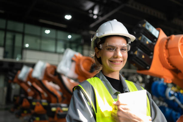istock Portrait of female engineer with the mission of auditing, testing, improving software and calibrating robotics arm. 1488621071