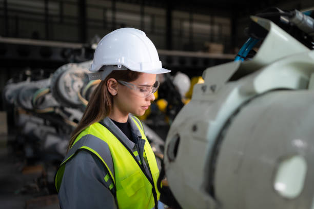 istock In the robots warehouse, Female engineer happily with updating software and calibrating a robotics arm. 1488622602