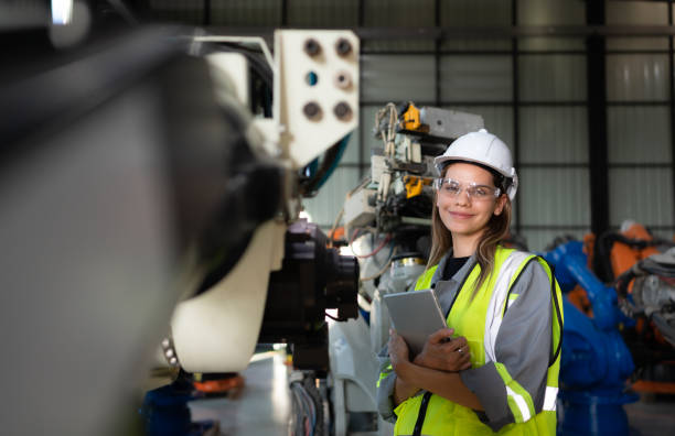 istock In the robots warehouse, Female engineer happily with updating software and calibrating a robotics arm. 1488622855