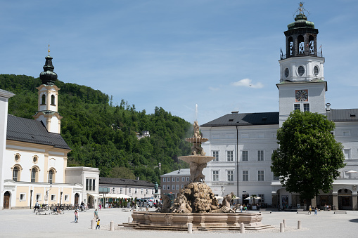 Salzburg, Austria - May 11, 2022: Residenzplatz (Residence Square), with the Residenzbrunnen (Residence Fountain), Church of St. Michael (left) and Neue Residenz (New Residence).