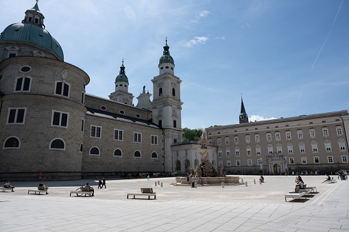 Salzburg, Austria - May 11, 2022: Residenzplatz (Residence Square), with the Salzburg Cathedral, Residenzbrunnen (Residence Fountain) and Alte Residenz (Old Residence, also known as Salzburg Residenz).