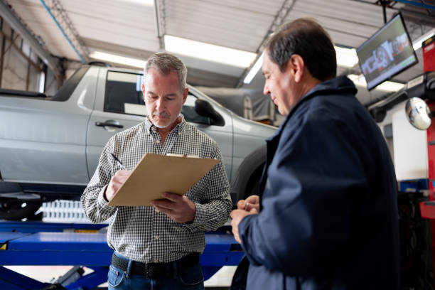 istock Man leaving his car at the garage and signing a form 1488626518