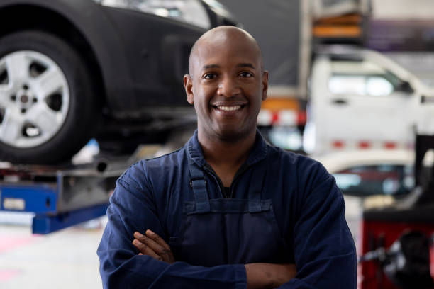 istock Happy mechanic working at a car garage 1488626527