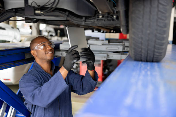 istock Mechanic working at an auto repair shop using a scanner on a car 1488626626