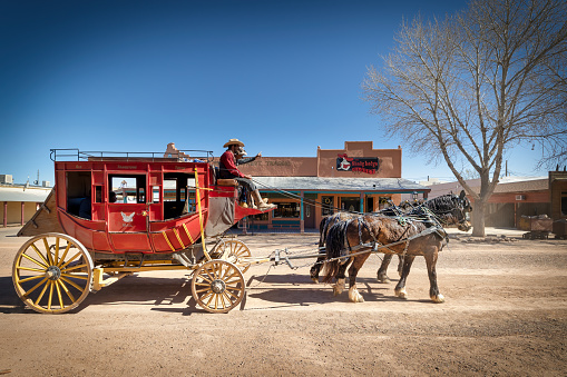 Tombstone, Arizona, USA - March 27, 2023: A horse drawn carriage makes its way through the streets of old west town's historic district.