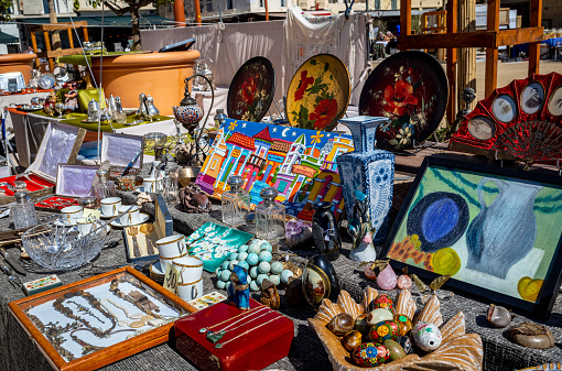 Selling a variety of antiques at a flea market. Garage sale of old collection items.