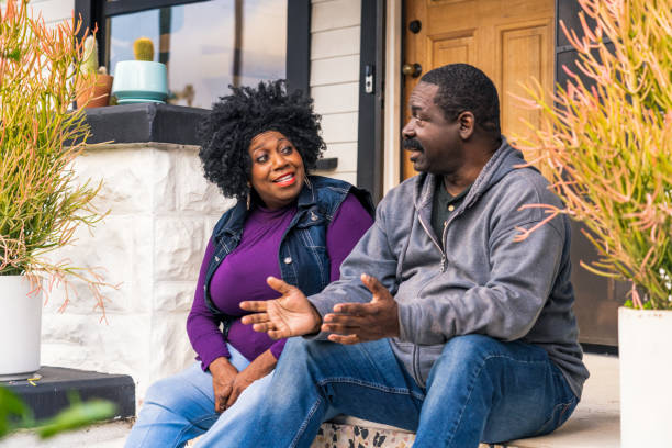 istock Couple chatting at the front of their home 1488630827