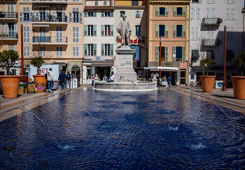 Views of the central town square in Cannes, France.  The square is the venue for many important events and on the weekend it serves as the location for the weekly flea market.  Always busy with tourists and residents, people come to the square to enjoy the cafes, restaurants, fountains, and general relaxation.