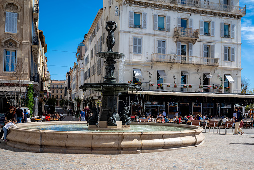 Views of the central town square in Cannes, France.  The square is the venue for many important events and on the weekend it serves as the location for the weekly flea market.  Always busy with tourists and residents, people come to the square to enjoy the cafes, restaurants, fountains, and general relaxation.
