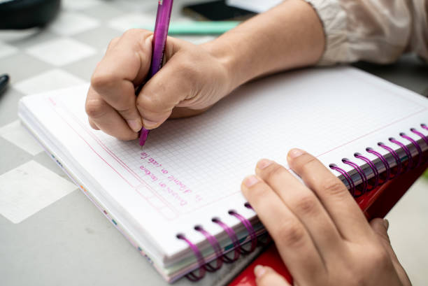 istock Close-up of a woman writing on notepad 1488633511