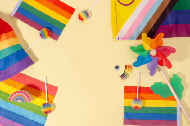 istock Happy Pride frame copy space with Lgtbiq+ flags, rainbow lollipop, rainbow hat on a light yellow background 1488633891