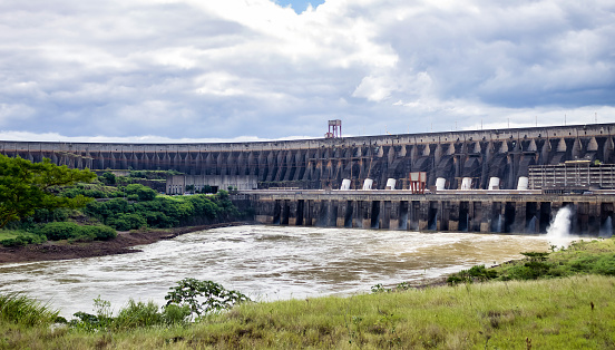 Photo of modern giant dam, located on Parana river. Itaipu Binacional hydroelectric power station in Foz do Iguazu Brazil on border with Paraguay. Hydro electrification concept. Copy ad text space