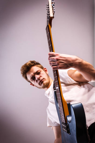 istock Young man is playing electric guitar 1488635243