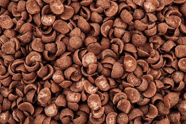istock Chocolate cereal flakes background. Crispy chocolate crunch corn flakes. Chocolate cornklakes background stock photo 1488638213