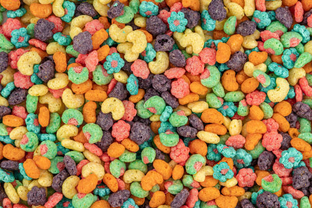 istock Fruit Cereal background. Fruit cereal naturally and artificially fruit flavored sweetened corn puffs. Cereal fruity shapes 1488638216