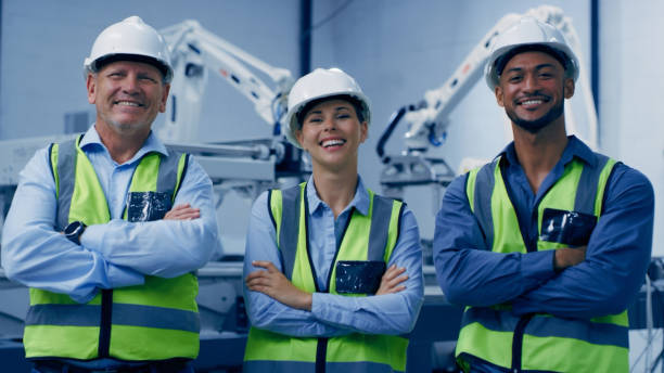 istock Arms crossed, people portrait and engineering, manufacturing robotics and teamwork with research leadership. Happy, diversity and proud woman with men or technician for machine, electronics or design 1488638376