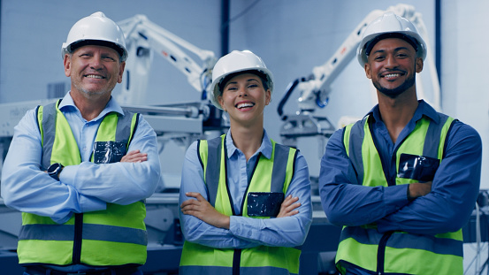 Arms crossed, people portrait and engineering, manufacturing robotics and teamwork with research leadership. Happy, diversity and proud woman with men or technician for machine, electronics or design