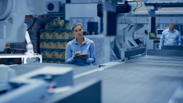 istock Automation, engineering and tablet with woman in laboratory for ai research, technology or science. Futuristic, robot and manufacturing with engineer in factory for industry, designer or planning 1488638558