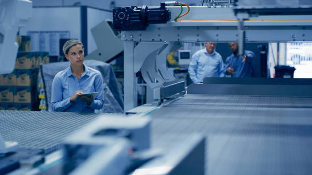istock Automation, engineering and tablet with woman in laboratory for ai research, technology or science. Futuristic, robot and manufacturing with engineer in factory for industry, designer or planning 1488638559
