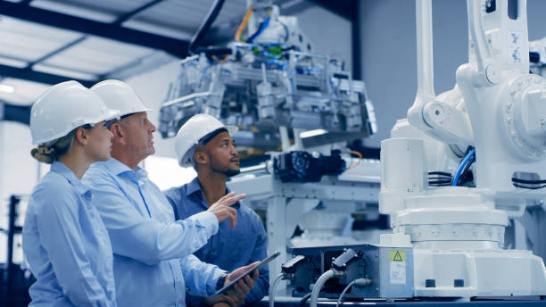 istock Engineering, tablet and people in lab with automation machine for analysis, research and inspection. Technology, collaboration and men and woman on digital tech for robotic  equipment and software 1488640268