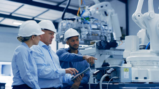 istock Automation, robotic lab and people on tablet on machine for analysis, research and engineering inspection. Technology, teamwork and men and woman on digital tech for futuristic data and software 1488640278